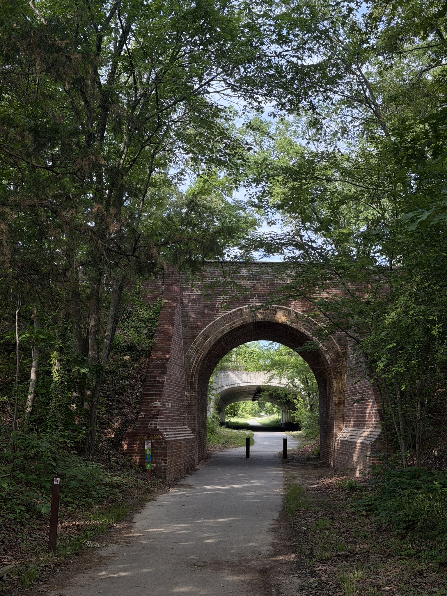Trail with brick tunnel and greenery around